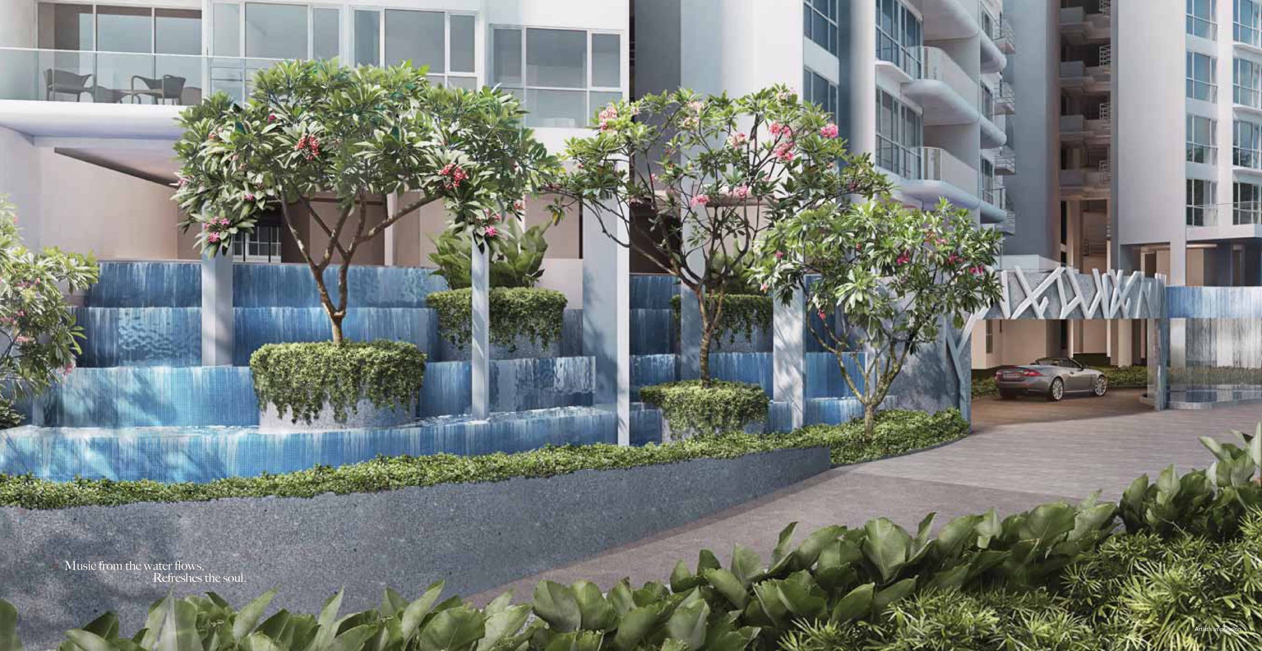 Entrance view of Riversound Residence featuring a cascading tiered water feature surrounded by lush greenery and flowering trees, with a sheltered driveway leading to the residential towers. A luxury car is seen entering the development, highlighting the upscale atmosphere and tranquil design.