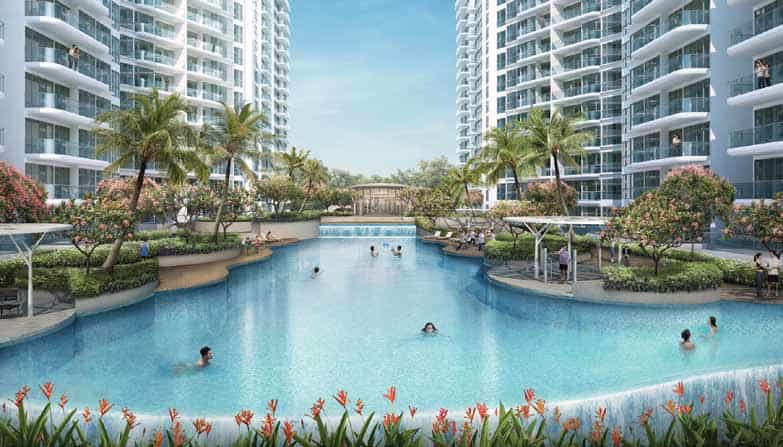 Central pool area at Riversound Residence surrounded by high-rise residential towers, featuring a large freeform swimming pool with lush landscaping, palm trees, and poolside cabanas. Residents are seen swimming and relaxing in a resort-style setting designed for leisure and comfort.
